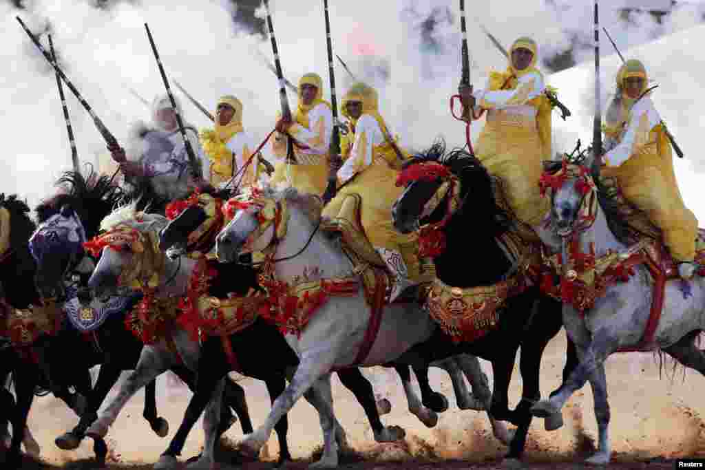 Horse riders perform with guns during the El-Jadida International Horse Show in El-Jadida, south of Casablanca, Morocco, Oct. 21, 2017.