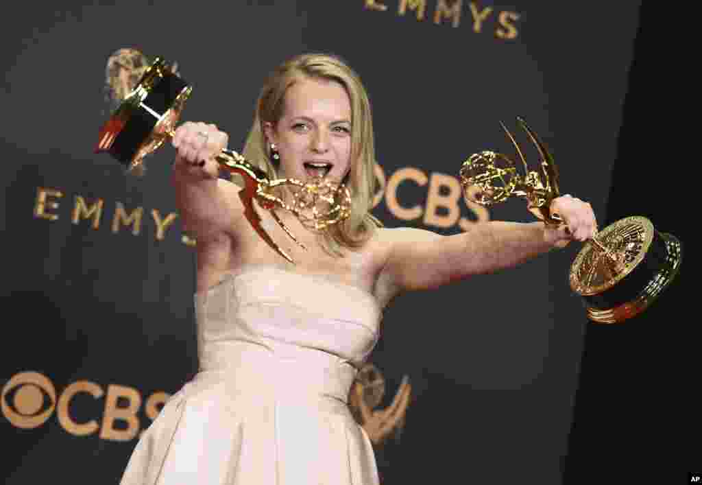 Elisabeth Moss poses in the press room with her awards for Outstanding Lead Actress in a drama series and Outstanding Drama Series for "The Handmaid's Tale" at the 69th Primetime Emmy Awards on Sunday, Sept. 17, 2017, at the Microsoft Theater in Los Angeles.