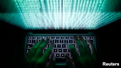 FILE - An illustration picture shows a man using a computer keyboard to enter data.