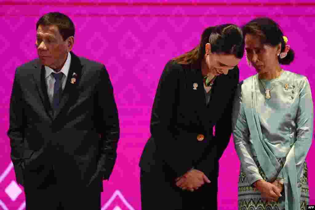 Myanmar's State Counsellor Aung San Suu Kyi (R) talks to New Zealand's Prime Minister Jacinda Ardern next to Philippines' President Rodrigo Duterte (L) during the 14th East Asia Summit in Bangkok, Thailand.