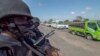 In this image made from video, Rwandan police patrol a road in Palma, Cabo Delgado province, Mozambique, Aug. 15, 2021. A new offensive by Mozambique's Islamic extremist rebels in Cabo Delgado has increased the number of displaced by 80,000 and undermines