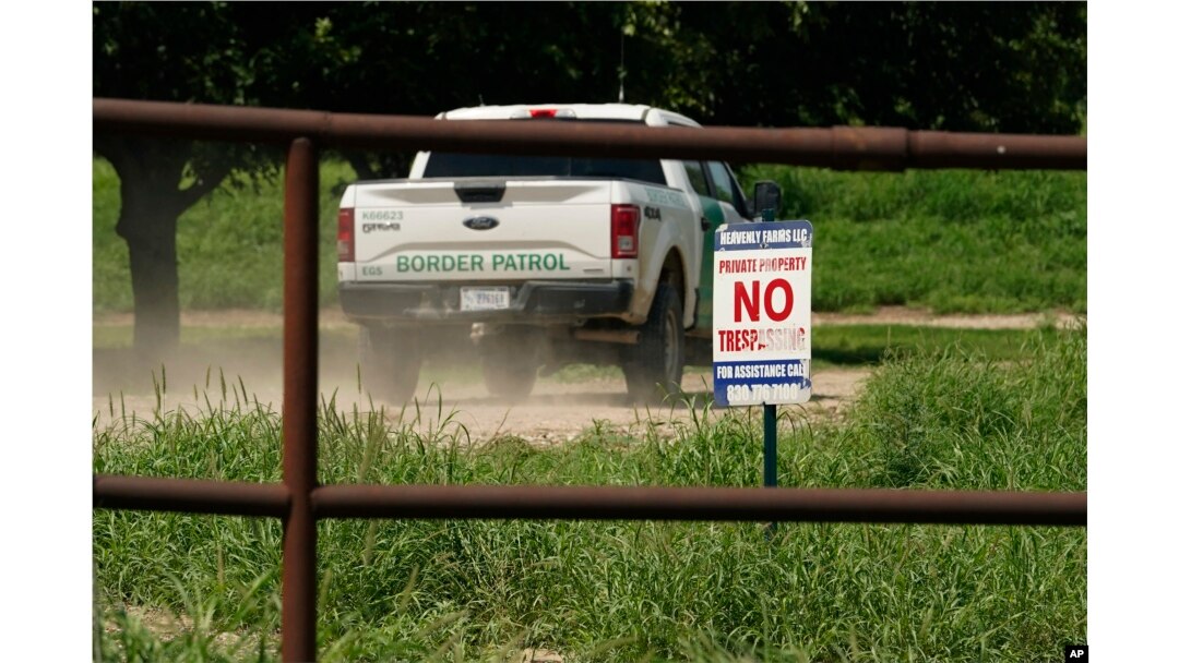 A Border Patrol vehicle enters Heavenly Farms, a pecan farm owned by Hugo and Magali Urbina, Friday, Aug. 26, 2022, in Eagle Pass, Texas. The area has become entangled in a turf war between the Biden administration and Texas Gov. Greg Abbott over how to police the U.S. border with Mexico. (AP Photo/Eric Gay)