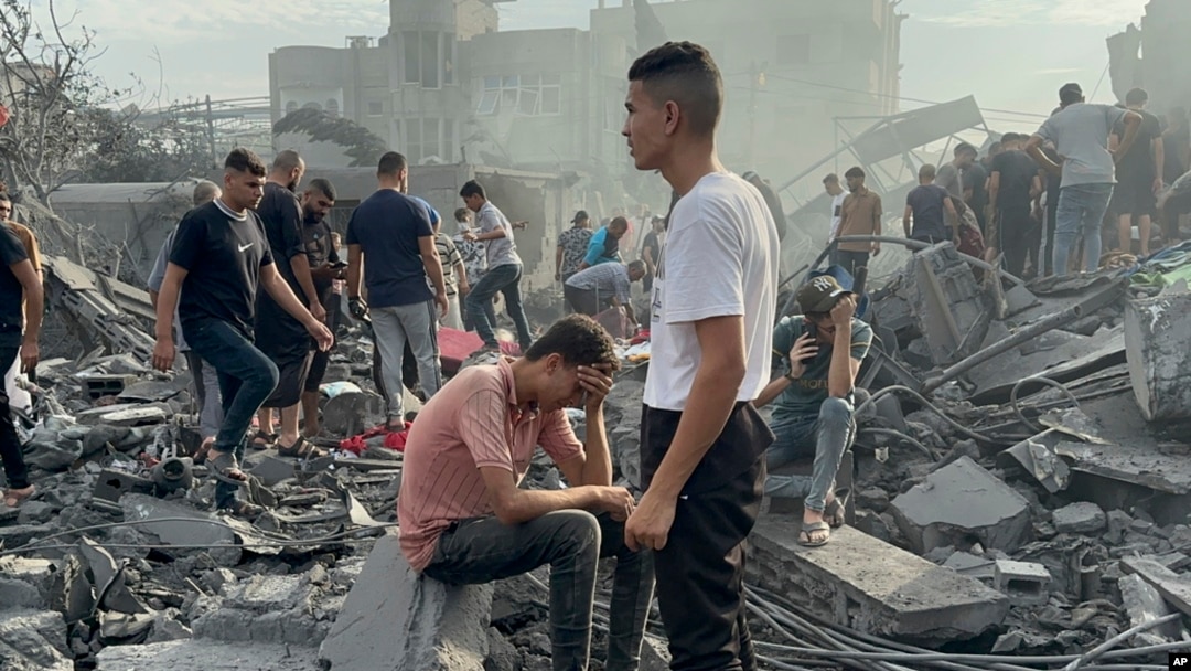 FILE - Palestinians look for survivors following an Israeli airstrike in Nusseirat refugee camp, Gaza Strip, Oct. 31, 2023. Aid for 2.7 million people in Gaza and the West Bank will cost $1.2 billion, a U.N. humanitarian office spokesman said November 3.