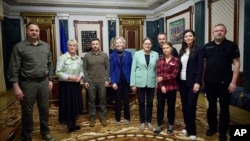 In this photo provided by the Ukrainian Presidential Press Office, Ukrainian President Volodymyr Zelenskyy, third from left, poses with eco-activist Greta Thunberg, third right, and European and Ukrainian officials in Kyiv, Ukraine, June 29, 2023.