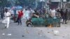Protesters pelt stones as they clash with police during the ongoing anti-quota protest in Dhaka on July 19, 2024.