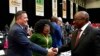 FILE - South African President Cyril Ramaphosa, right, greets opposition Democratic Alliance (DA) leader, John Steenhuisen, left, at the first sitting of Parliament since elections, in Cape Town, June 14, 2024. 