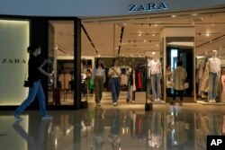People are seen in a ZARA flagship store at a shopping mall in Beijing, June 21, 2023.