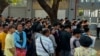 People gather outside the embassy of Thailand to get visas in Yangon on February 16, 2024, after Myanmar's military government said it would impose military service. 