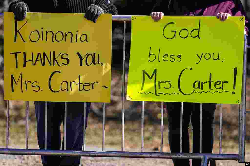 People watch the motorcade as it moves to Maranatha Baptist Church where the funeral service for former first lady Rosalynn Carter will be held, in Plains, Georgia, Nov. 29, 2023. The former first lady died on Nov. 19. She was 96. With her frail husband as a silent witness, Rosalynn Carter was celebrated by her family and closest friend at her funeral in the same tiny town where she and Jimmy Carter were born, forever their home base as they climbed to the White House and traveled the world for humanitarian causes.