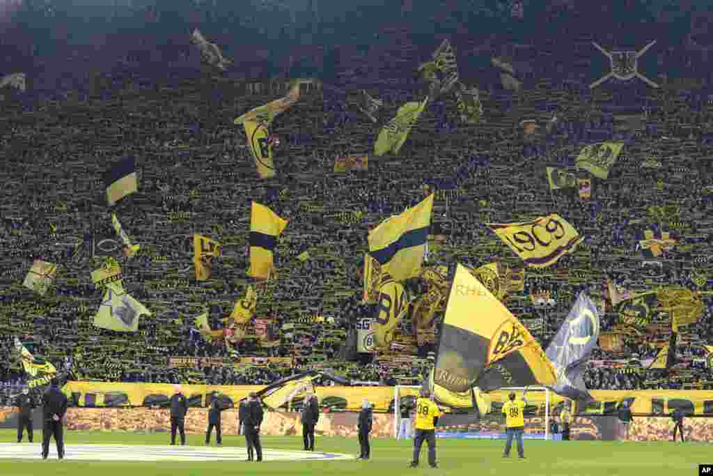 Dortmund supporters wave flags before the German Bundesliga soccer match between Borussia Dortmund and TSG Hoffenheim in Dortmund, German.