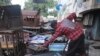 A man starts a petrol generator at his shop in Abuja, Nigeria, June 17, 2023. 