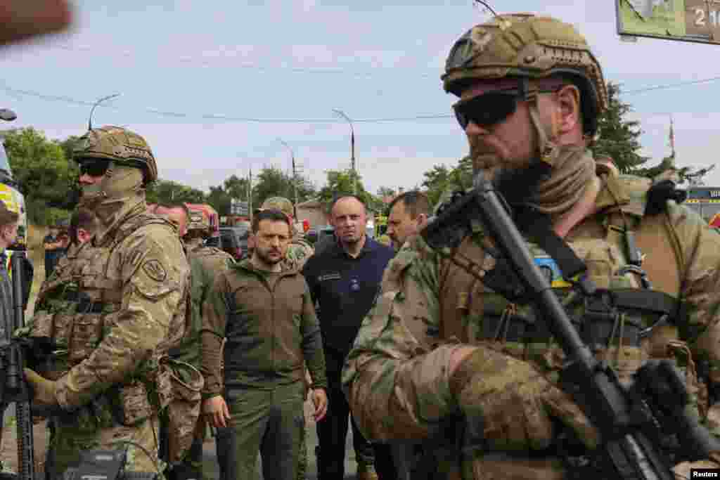 Ukraine's President Volodymyr Zelenskiy visits a flooded area after the Nova Kakhovka dam breached, in Kherson, June 8, 2023.