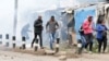 Supporters of Kenya's opposition leader Raila Odinga run after riot police officers lobbed teargas to disperse them during an anti-government protest in Nairobi, Kenya July 7, 2023.