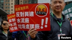 Protesters demonstrate against a land reclamation and waste transfer station project during one of the first demonstrations to be formally approved since the enactment of a sweeping national security law, in Hong Kong, March 26, 2023. 