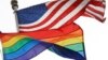 FILE - The Rainbow Flag, an international symbol of LGBT liberation and pride, flies beneath the American flag at the Stonewall National Monument on Oct. 11, 2017, in New York.
