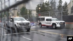 Crews try to dry the track in the rain before a NASCAR Cup Series auto race at the Grant Park 220, July 2, 2023, in Chicago.