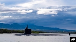 FILE - The Virginia-class fast-attack submarine USS Missouri departs Joint Base Pearl Harbor-Hickam, Sept. 1, 2021. Australia will purchase US-manufactured, Virginia-class nuclear-powered submarines to modernize its fleet. (Amanda R. Gray/US Navy via AP)