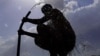 FILE - A man bathes in a village on the outskirts of Ajmer during the longest heat wave ever to hit India, June 11, 2024. The government's top weather expert had warned people that they would face increasingly oppressive temperatures. 
