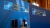 People walk inside the Walter E. Washington Convention Center, which has been decorated with signage in preparation for the NATO summit, July 8, 2024. 