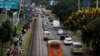 FILE - Cars and pedestrians line the road in Nairobi, Kenya, March 27, 2020. Road deaths have increased in Africa in the past decade, due to poor safety standards and lack of enforcement of safety laws.