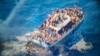1 year later, migrants who survived wreck off Greece seek justice 