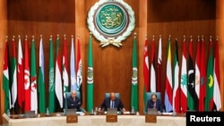 Secretary General of the Arab League Ahmed Aboul Gheit reacts next to Egypt's Foreign Minister Sameh Shoukry during the opening session of the meeting of Arab foreign ministers, to discuss the Syrian situation and Sudan crisis, in Cairo, Egypt, May 7, 2023.
