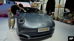 FILE - A worker wipes an Ora, a Chinese electric car, during the Auto Shanghai 2023 at a convention center in Shanghai, April 18, 2023. A new set of tariff increases on certain Chinese goods set to take effect on Aug. 1, 2024, is being delayed. 