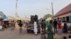 FILE - Nigerian security forces are seen in a street in Chibok, March 31, 2024. Almost 100 of the 276 girls seized from their school in Chibok by Boko Haram fighters in 2014 are still thought to be in captivity. 