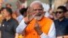Indian Prime Minister Narendra Modi, shows the indelible ink mark on his index finger after casting his vote during the third phase of general elections, in Ahmedabad, Gujarat, India, May 7, 2024. 