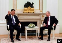 Chinese President Xi Jinping, left, gestures while speaking to Russian President Vladimir Putin during their meeting at the Kremlin in Moscow, Russia, March 20, 2023.
