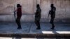 FILE - U.S. backed Syrian Democratic Forces soldiers search for Islamic State militants in Hassakeh, Syria, Jan. 28, 2022. 
