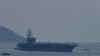 The USS Ronald Reagan, a US Navy Nimitz-class nuclear-powered aircraft carrier, pulls into port in Danang on June 25, 2023. 