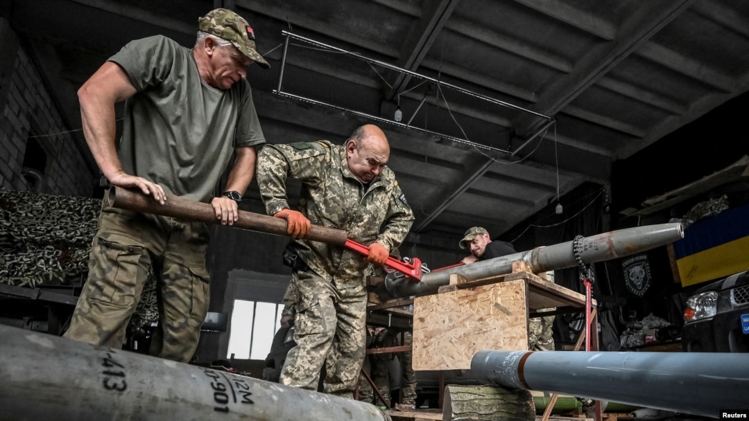 Members of the company tactical group "Steppe Wolves" of the Voluntary Formation of the Zaporizhzhia Territorial Community disassemble a shell for a BM-21 Grad multiple launch rocket system in Zaporizhzhia region, Ukraine, April 26, 2024.