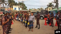 Myanmar's nationals who crossed the border to seek shelter in Bangladesh are escorted back to their country by ships at Cox's Bazar on April 25, 2024. Bangladesh on April 25 sent home nearly 300 Myanmar soldiers and civil servants who fled to escape rebel attacks. 