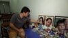Vincent Khor Wei Fong set up a tribute in his home to his wife, Chin Su King, and 5-year-old son, Daniel Khor Yen Hong, who were both killed by a landslide in December 2022. (Dave Grunebaum/VOA)