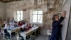 FILE - A teacher instructs young girls in Kabul, Afghanistan, March 25, 2023. The Taliban have prohibited girls from attending school beyond the sixth grade.