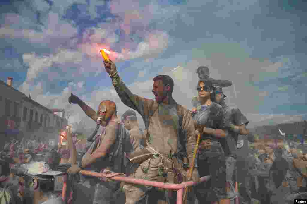 Revelers participate in a colorful "flour war", celebrating the "Ash Monday" or "Clean Monday", a traditional festivity marking the start of the 40-day Lent period until the Orthodox Easter, in the town of Galaxidi, Greece.