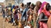 Women who fled the war-torn Sudan queue to receive food rations at the United Nations High Commissioner for Refugees (UNHCR) transit centre in Renk, near the border crossing point in Renk County of Upper Nile State, South Sudan May 1, 2023. 
