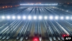 FILE - High-speed trains are lined up after undergoing maintenance in preparation for the annual Lunar New Year travel peak, at a maintenance base in Wuhan, in China's central Hubei province.