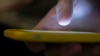 FILE - A man uses a cellphone in New Orleans on Aug. 11, 2019. 