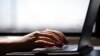 FILE - This May 18, 2021, photo shows a woman typing on a laptop in New Jersey. 