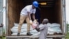 FILE - Workers unload agricultural products from a truck in Uganda on Oct. 11, 2022. The U.S. State Department has warned investors of the financial and reputational risks posed by endemic corruption in Uganda. (Business Wire via AP)