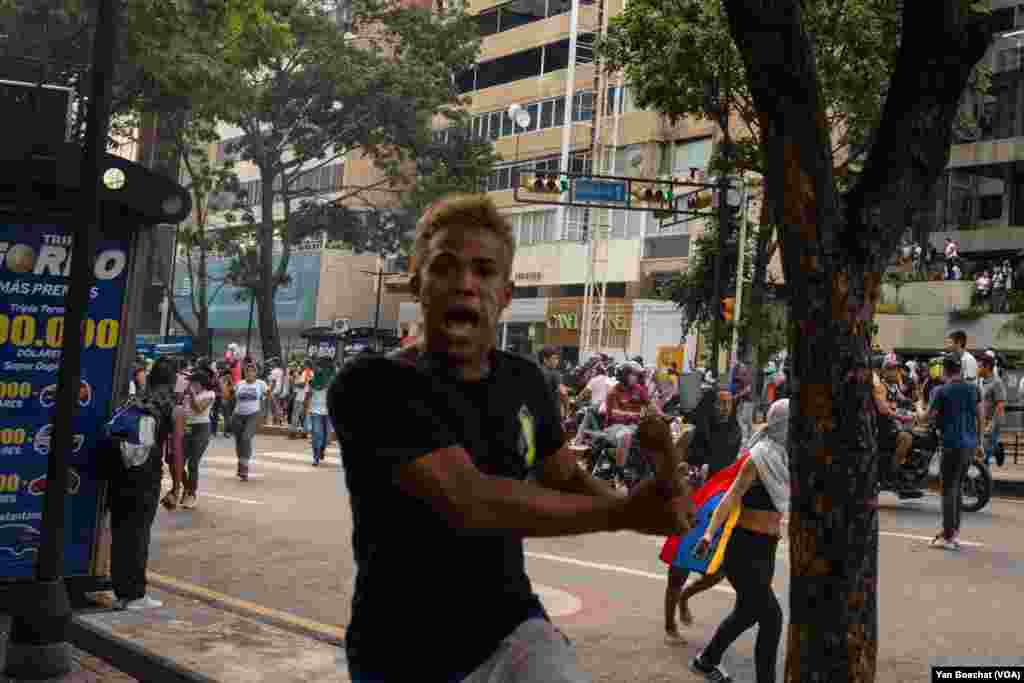 After marching from one of the poorest neighborhoods in Caracas, young Venezuelans clash with the armed forces in the capital's central district, July 29, 2024. 