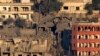 FILE - Destroyed houses in Khiam, a town near the Lebanese-Israeli border, that was hit by Israeli air strikes on Friday June 21, seen from the Lebanese town of Marjayoun, Lebanon, June 22, 2024.