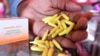 FILE - A beautician displays capsules and cream used for skin-lightening at a beauty shop, in Nairobi, Kenya, July 6, 2018.