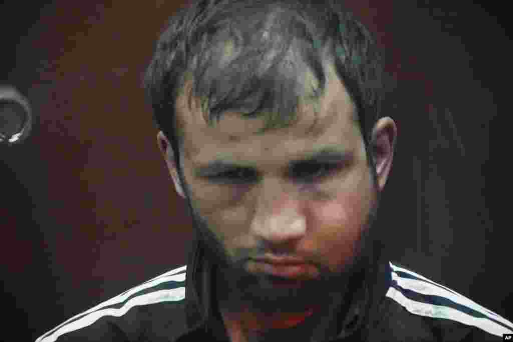 Shamsidin Fariduni, a suspect in the Crocus City Hall shooting on Friday, sits in a glass cage in the Basmanny District Court in Moscow, Russia, March 24, 2024.