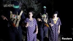 Yocheved Lifshitz and Nurit Cooper, who were held hostage by Palestinian Hamas militants, are released by the militants, in this video screengrab obtained by Reuters on Oct. 23, 2023. (Al-Qassam Brigades, military wing of Hamas)