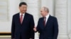 FILE - Russian President Vladimir Putin, right, speaks to Chinese President Xi Jinping as they attend an official welcome ceremony at The Grand Kremlin Palace, in Moscow, March 21, 2023.