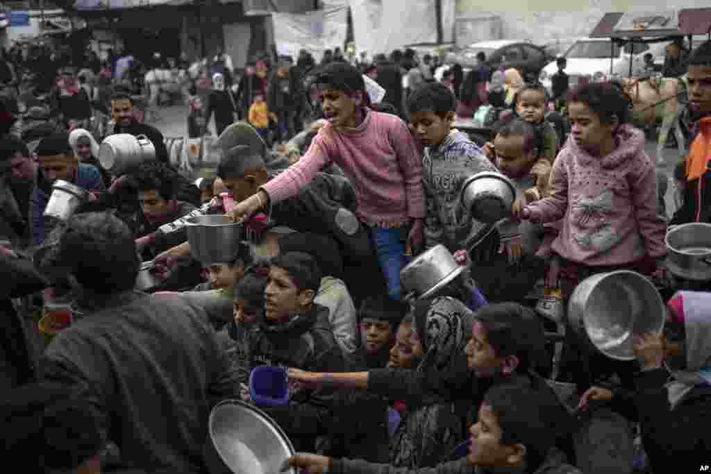 Palestinians line up for a free meal in Rafah, Gaza Strip, Dec. 21, 2023. International aid agencies say Gaza is suffering from shortages of food, medicine and other basic supplies as a result of the two and a half month war between Israel and Hamas.
