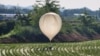 A balloon believed to have been sent by North Korea, carrying various objects including what appeared to be trash and excrement, is seen over a rice field at Cheorwon, South Korea, May 29, 2024. (Yonhap via Reuters)